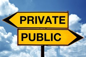 Private or public, opposite signs. Two opposite signs against blue sky background.