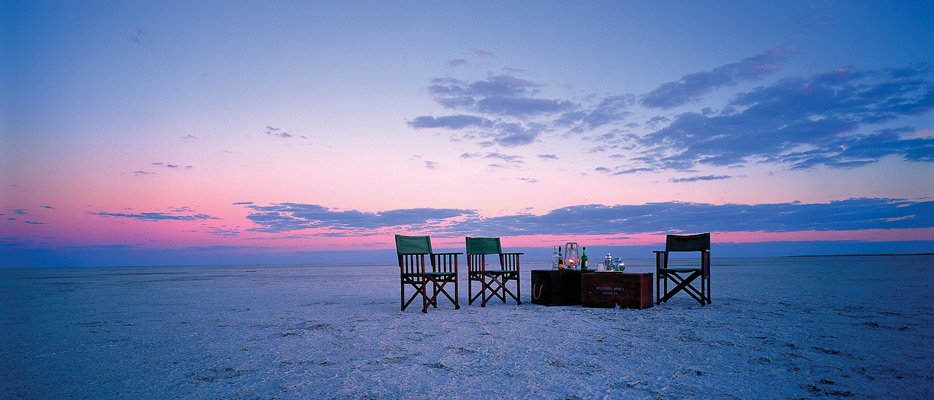 3 chair on beach scene in open plain with dust background in botswana