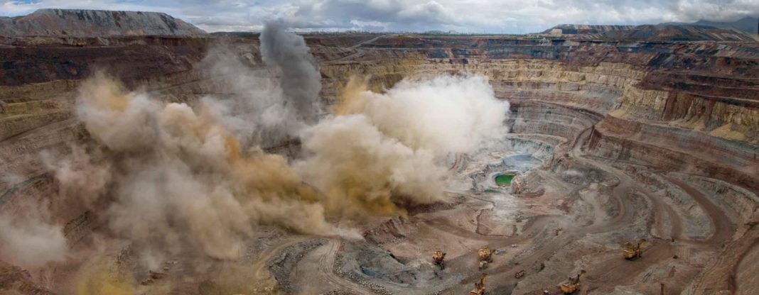 a picture of open pit mine blasting