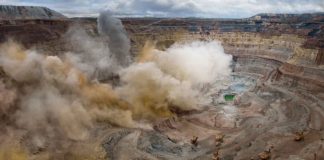 a picture of open pit mine blasting