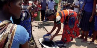 A woman in the process of making Green Charcoal in Zambia