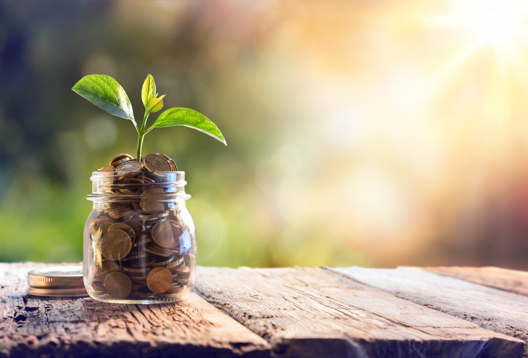Money growing in a jar showing economic multiplier effect