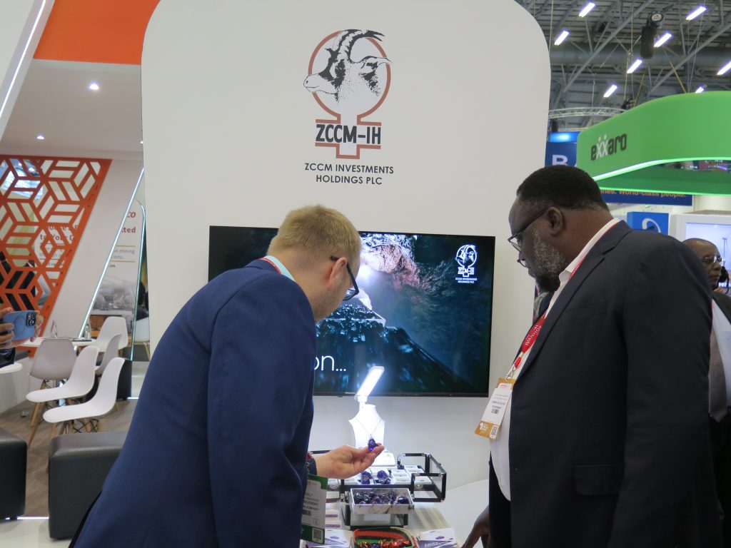 Zambia's Mines Minister and an Indaba attendee peruse Kariba Minerals' stand