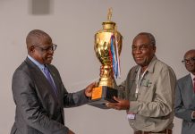 Safety is a shared mindset Permanent Secretary at the Ministry of Mines and Minerals Development, Dr Hapenga M. Kabeta, handing the trophy to the Chairman of the Board at Kagem, Dr Sixtus Mulenga