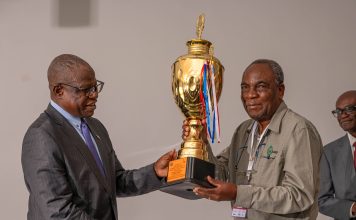 Safety is a shared mindset Permanent Secretary at the Ministry of Mines and Minerals Development, Dr Hapenga M. Kabeta, handing the trophy to the Chairman of the Board at Kagem, Dr Sixtus Mulenga